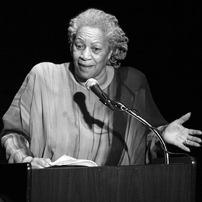 Toni Morrison delivering a speech at a podium in 2008 